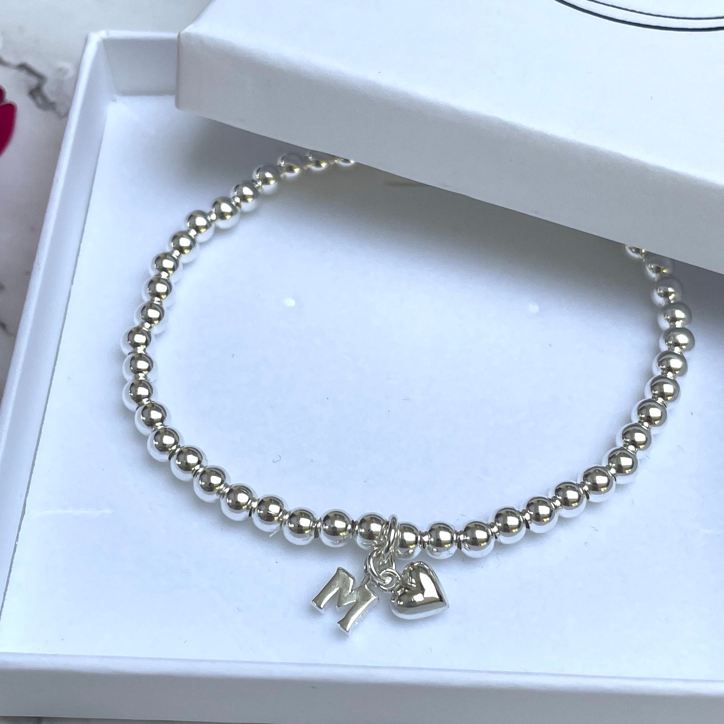 Silver plated elasticated bead bracelet with initial charm & heart