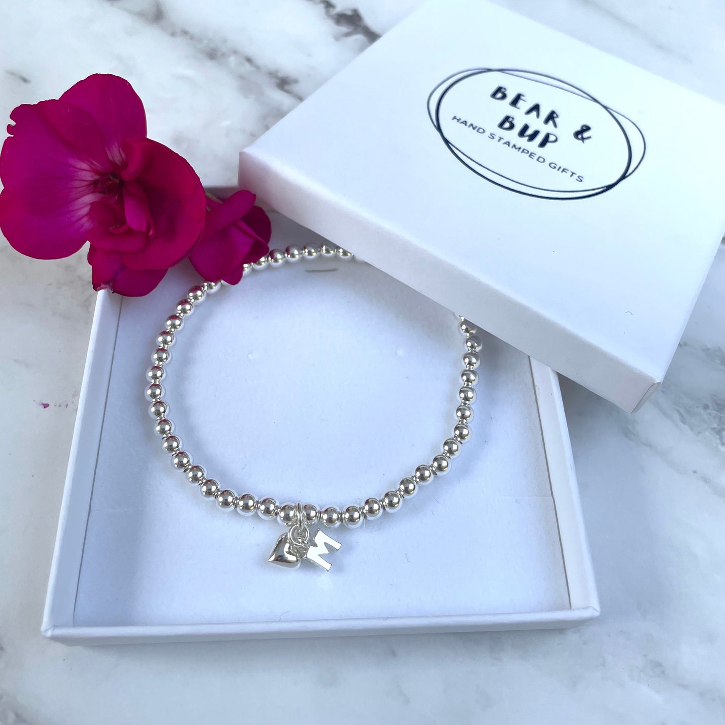 Silver plated elasticated bead bracelet with initial charm & heart