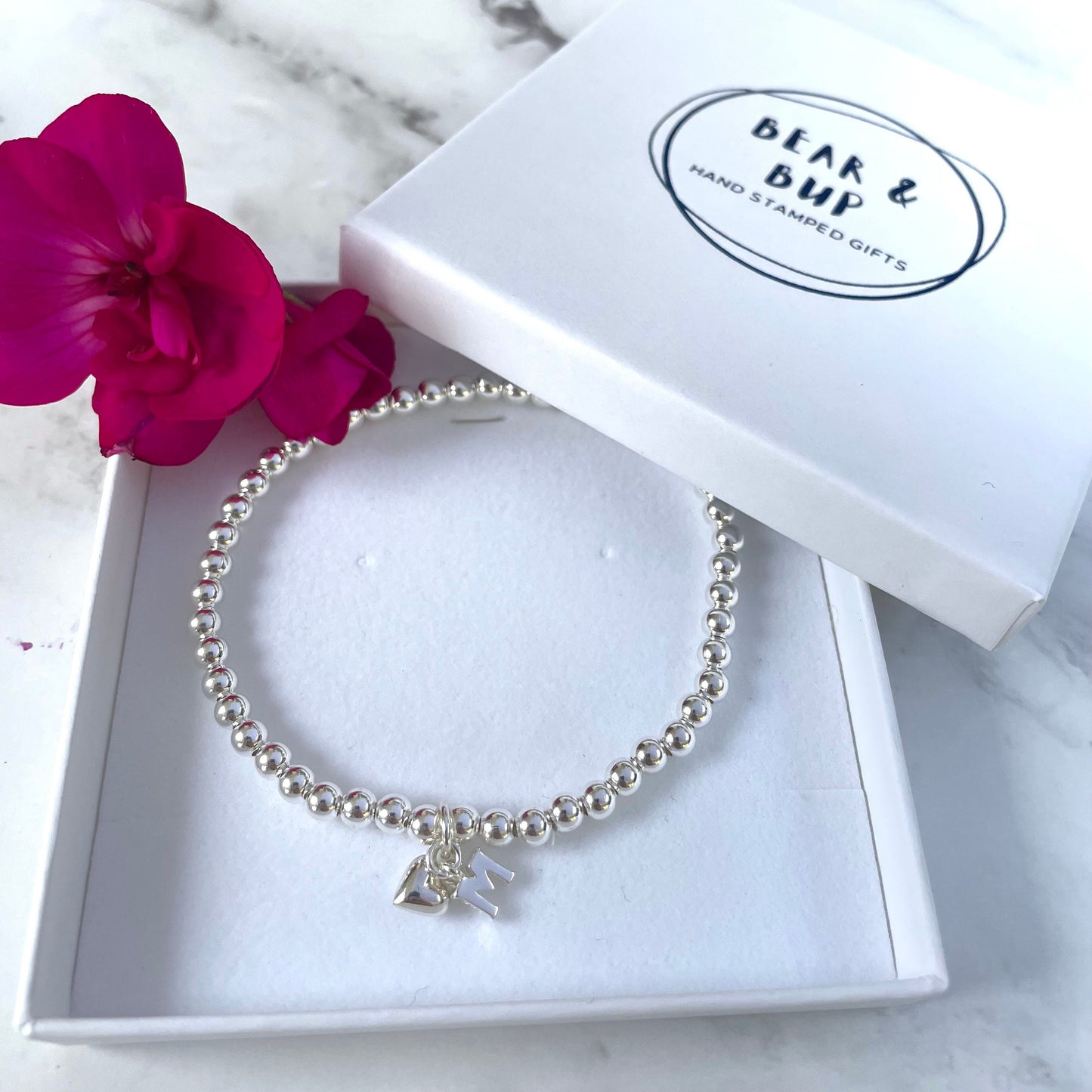 Silver plated elasticated bead bracelet with initial charm & heart